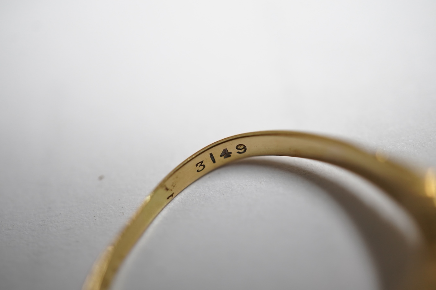 An early 20th century yellow metal and three stone sapphire set half hoop ring, the central stone bordered with rose cut diamonds, size M, gross weight 3 grams.